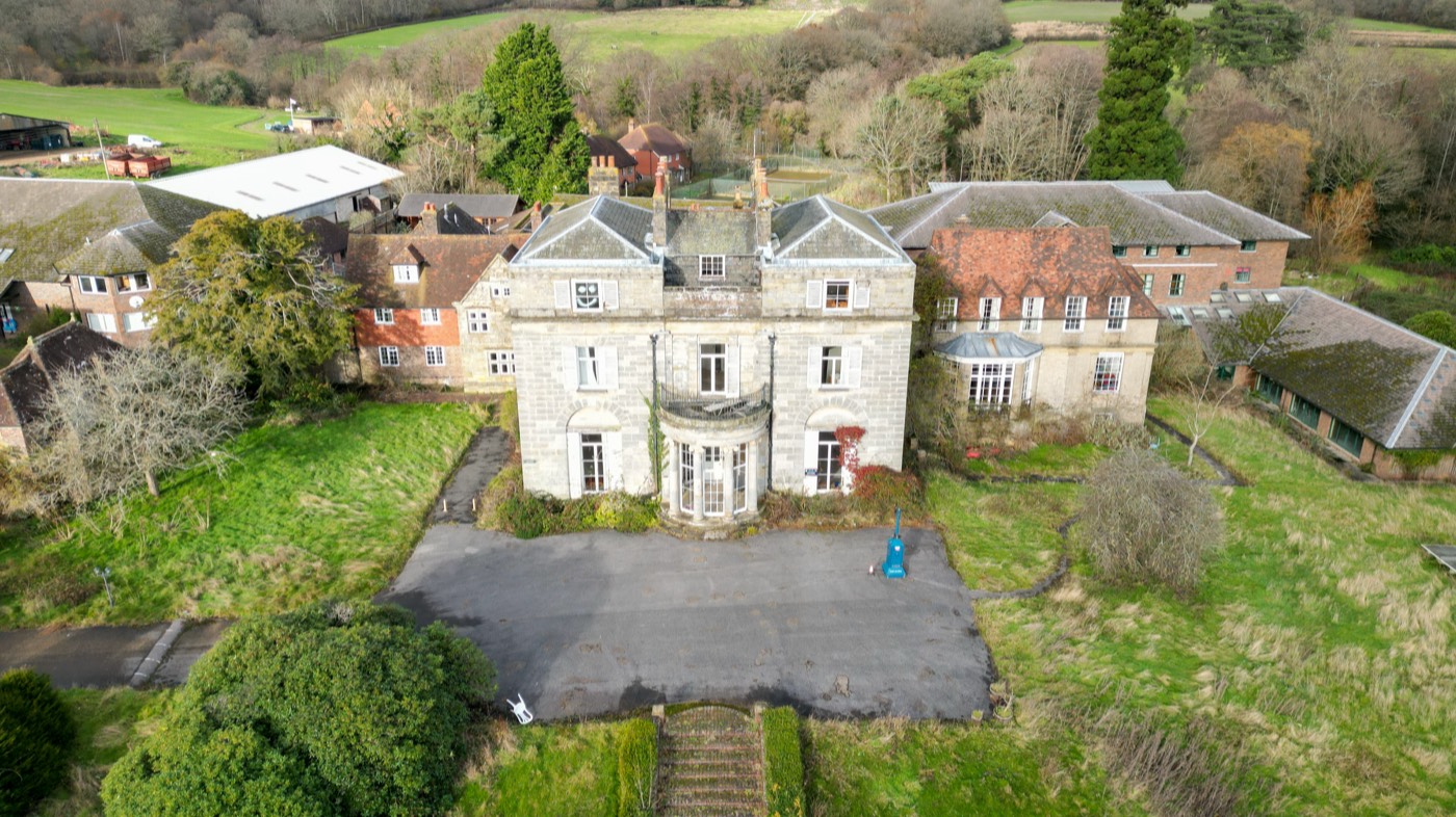 A large country house and its grounds from the air