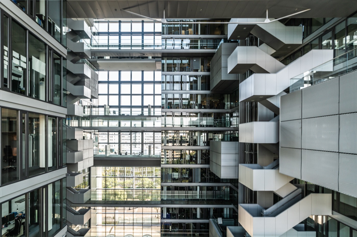 A multi-storey office atrium with glass balustrades